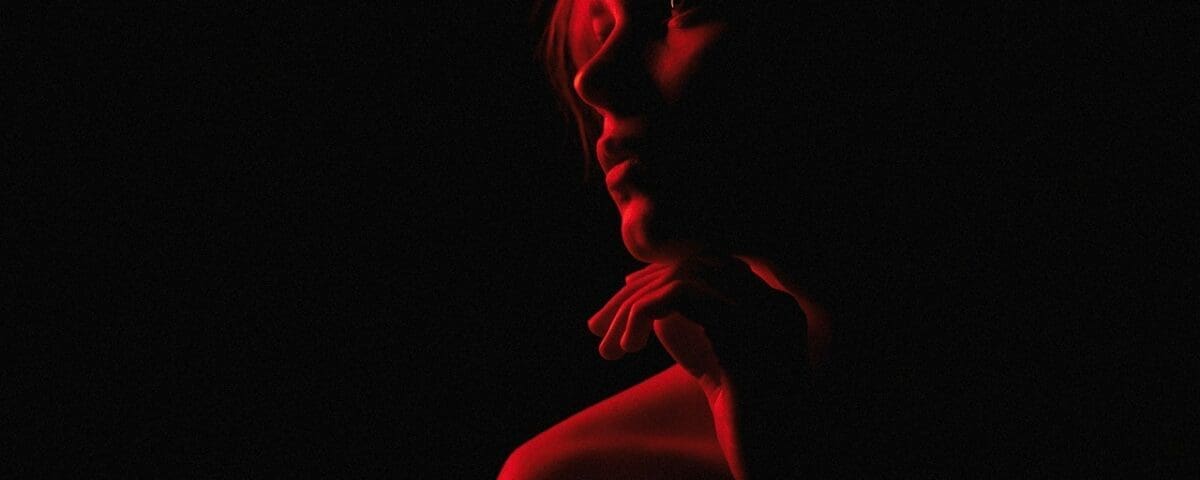Image of a woman with red light shining on her