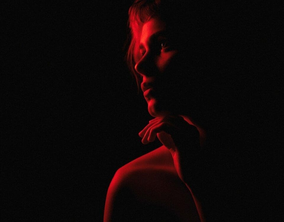 Image of a woman with red light shining on her