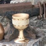 Image of a anvil and a golden goblet