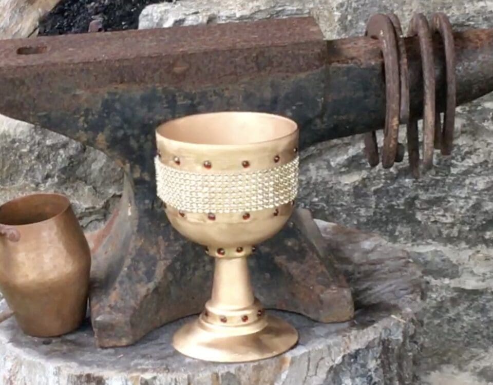 Image of a anvil and a golden goblet