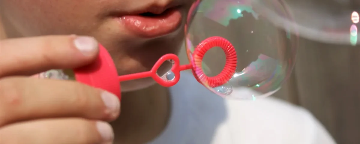 Image of a kid blowing bubbles