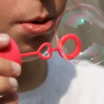 Image of a kid blowing bubbles
