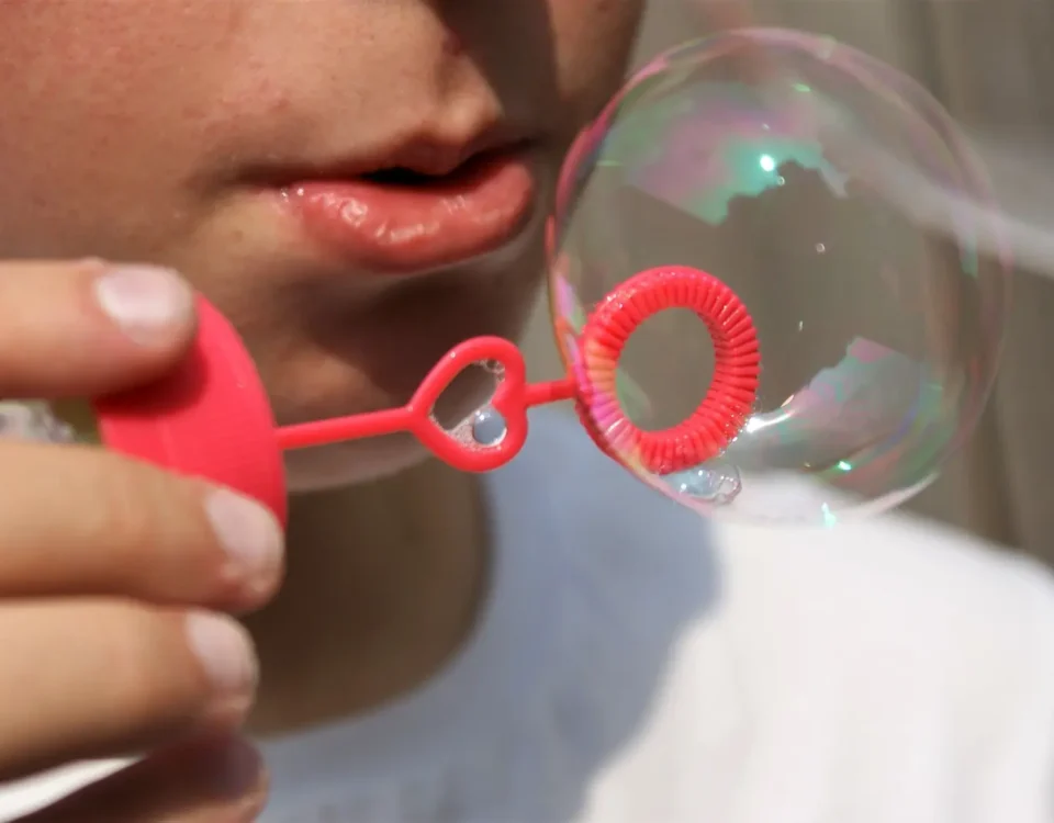 Image of a kid blowing bubbles
