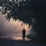 Image of a person walking down a lonely road