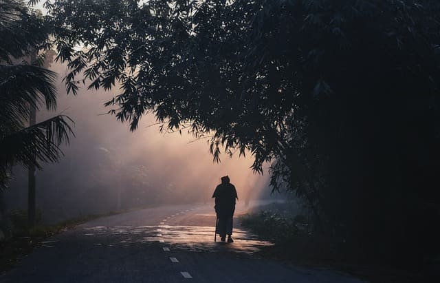 Image of a person walking down a lonely road