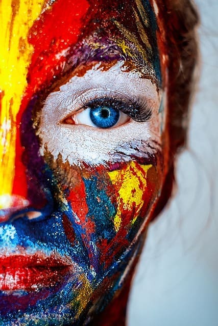 Image of a painted face with an eye looking at you